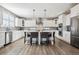 Modern kitchen with a large island, pendant lighting, and sleek stainless steel appliances at 21854 Tyrolite Ave, Parker, CO 80138