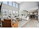 Spacious living room with hardwood floors, lots of natural light, and views of the dining and kitchen areas at 21854 Tyrolite Ave, Parker, CO 80138