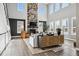 Bright living room with stone fireplace, hardwood floors, and many windows with plantation shutters at 21854 Tyrolite Ave, Parker, CO 80138