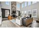 Bright living room featuring a stone fireplace, high ceilings, and a comfortable seating area at 21854 Tyrolite Ave, Parker, CO 80138