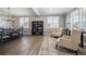 Bright living room featuring hardwood floors, large windows, and a decorative chandelier at 21854 Tyrolite Ave, Parker, CO 80138