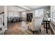 Bright living room featuring hardwood floors, large windows, and a decorative chandelier at 21854 Tyrolite Ave, Parker, CO 80138