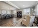 Bright living room featuring hardwood floors, large windows, and a decorative chandelier at 21854 Tyrolite Ave, Parker, CO 80138