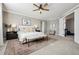 Spacious main bedroom with a bench, large windows, and carpeted floors at 21854 Tyrolite Ave, Parker, CO 80138