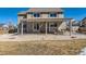 Spacious backyard with pergola, white rock ground cover, privacy fence, and mature landscaping at 1537 Rosedale St, Castle Rock, CO 80104