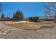 Landscaped backyard with decorative rock, garden beds, wooden privacy fence, and small seating area at 1537 Rosedale St, Castle Rock, CO 80104