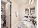 Bathroom featuring granite counters, double mirrors, and tile floors at 1537 Rosedale St, Castle Rock, CO 80104