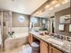 Bathroom with double sinks, granite countertops, and a separate shower and bathtub at 1537 Rosedale St, Castle Rock, CO 80104