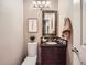 The bathroom has a dark wood vanity, mosaic tile backsplash, and a decorative framed mirror at 1537 Rosedale St, Castle Rock, CO 80104