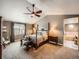Spacious bedroom with a four-poster bed, vaulted ceilings, and an attached bathroom at 1537 Rosedale St, Castle Rock, CO 80104