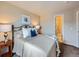 Bedroom features neutral decor, a bed with a blue accent pillow, and an ensuite bathroom at 1537 Rosedale St, Castle Rock, CO 80104