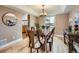 Elegant dining room featuring a modern chandelier, hardwood floors, and ample seating for dinner gatherings at 1537 Rosedale St, Castle Rock, CO 80104