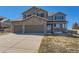 Well-maintained two-story home with a three-car garage, stone accents, covered porch, and mature landscaping at 1537 Rosedale St, Castle Rock, CO 80104
