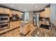 Spacious kitchen with stainless steel appliances, center island, granite counters and tile flooring at 1537 Rosedale St, Castle Rock, CO 80104
