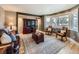 Cozy living room with a comfortable leather sofa, stylish furnishings, and large windows that offer ample sunlight at 1537 Rosedale St, Castle Rock, CO 80104