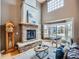 Bright living room with a stone fireplace, large windows, and comfortable seating creates a cozy ambiance at 1537 Rosedale St, Castle Rock, CO 80104