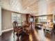 Inviting living room with hardwood floors, wooden ceiling, entertainment center, and views from the large windows at 1537 Rosedale St, Castle Rock, CO 80104