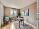Inviting home office with natural light, neutral tones, modern desk and a comfortable reading chair at 1537 Rosedale St, Castle Rock, CO 80104