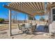 Cozy covered patio with an outdoor dining table, perfect for relaxing or entertaining at 1537 Rosedale St, Castle Rock, CO 80104