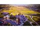 Aerial view of a golf clubhouse with lush green landscaping and an expansive golf course at 2861 Eagle Cir, Erie, CO 80516