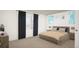 Comfortable bedroom with a plush bed, bedside tables, and ample natural light at 46545 Sunflower Ln, Bennett, CO 80102