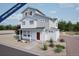 Charming two-story home with a red front door and a beautifully landscaped yard at 46545 Sunflower Ln, Bennett, CO 80102