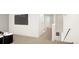 Bright hallway with access to multiple rooms, featuring neutral decor and ample lighting at 46545 Sunflower Ln, Bennett, CO 80102