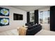 Bright living room featuring large windows, comfortable seating, and stylish decor with black-out curtains at 46545 Sunflower Ln, Bennett, CO 80102