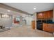 Large basement with a cabinet with bar area, neutral paint, carpet, recessed lighting, and simple wall decor at 5706 S Garland Way, Littleton, CO 80123