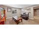 Relaxing basement area with a leather sofa, neutral paint, carpet, a window, and simple wall decor at 5706 S Garland Way, Littleton, CO 80123