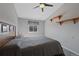 Neutral bedroom featuring a ceiling fan, carpet flooring, a window for natural light, and simple wall decor at 5706 S Garland Way, Littleton, CO 80123