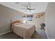 Neutral bedroom featuring a ceiling fan, carpet flooring, a window for natural light, and simple wall decor at 5706 S Garland Way, Littleton, CO 80123