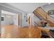 Hardwood floors lead from foyer to sitting room with staircase at 5706 S Garland Way, Littleton, CO 80123