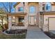 Inviting front porch with stone columns and charming bench seating at the home's entrance at 5706 S Garland Way, Littleton, CO 80123