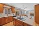 Bright kitchen featuring stainless steel appliances, hardwood floors and seamless flow to the Gathering room at 5706 S Garland Way, Littleton, CO 80123