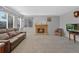 Cozy living room features a classic fireplace, large windows, and comfortable seating at 5706 S Garland Way, Littleton, CO 80123