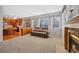 Open-concept living room features fireplace and seamless access to the adjacent kitchen at 5706 S Garland Way, Littleton, CO 80123