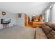 Spacious living room with wood floors, seamless to kitchen, and ample natural light at 5706 S Garland Way, Littleton, CO 80123