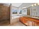 Bright main bathroom features a corner tub, walk-in shower, and dual sink vanity at 5706 S Garland Way, Littleton, CO 80123