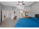 Bright main bedroom with a chair, dresser, and an adjoining bathroom at 5706 S Garland Way, Littleton, CO 80123