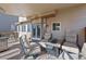 Spacious covered back patio featuring comfortable seating and a dining table, great for outdoor gatherings at 5706 S Garland Way, Littleton, CO 80123