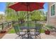 Cozy backyard patio featuring an umbrella-covered table and chairs, perfect for relaxation at 22302 Quail Run Way, Parker, CO 80138