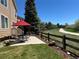 Relaxing backyard patio with table and chairs, adjacent to a walking path with wooden fence at 22302 Quail Run Way, Parker, CO 80138