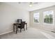 Bright bedroom featuring a desk, chair, and natural light from two windows at 22302 Quail Run Way, Parker, CO 80138