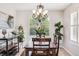 Dining room with wooden table, decorative chandelier, and a large window at 22302 Quail Run Way, Parker, CO 80138