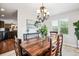 Open dining room with elegant lighting and adjacent kitchen at 22302 Quail Run Way, Parker, CO 80138