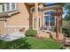 Close-up view of front entrance, showcasing stone accents, landscaping, and seating area at 22302 Quail Run Way, Parker, CO 80138