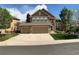 Charming two-story home featuring a three-car garage and well-manicured lawn at 22302 Quail Run Way, Parker, CO 80138