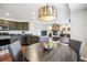 A kitchen with stainless steel appliances, granite countertops, and adjacent living room at 22302 Quail Run Way, Parker, CO 80138