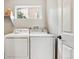 Functional laundry room with washer, dryer, and shelving for storage solutions at 22302 Quail Run Way, Parker, CO 80138